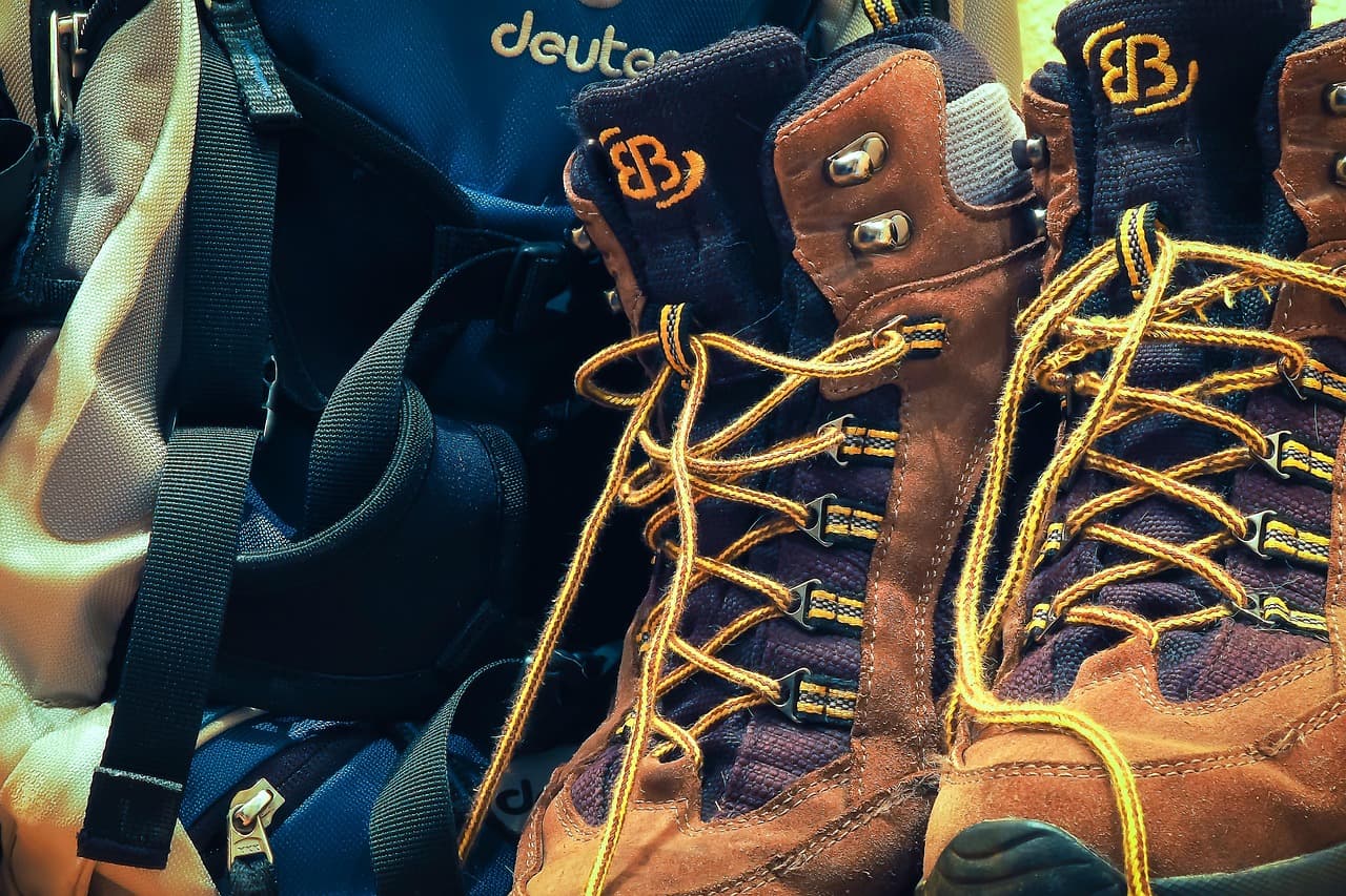 Hiking boots and backpack on a trail